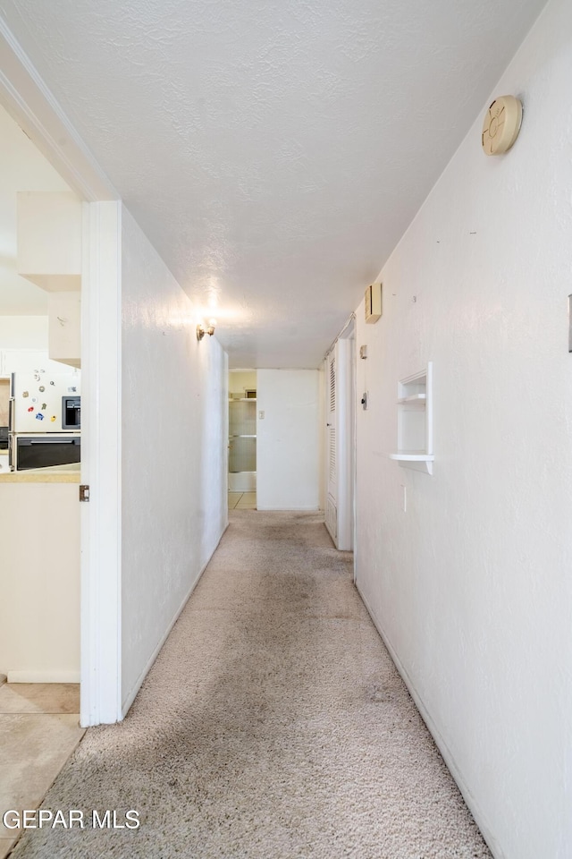 corridor with a textured ceiling