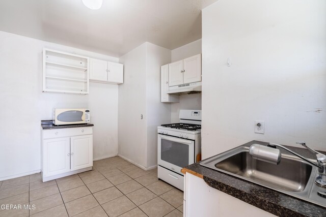 kitchen featuring sink, white cabinets, white appliances, and light tile patterned floors