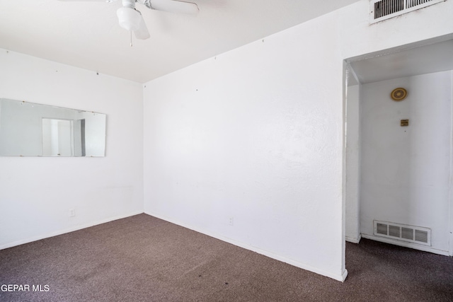 unfurnished room with carpet, visible vents, and ceiling fan