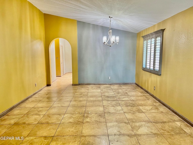 unfurnished room with lofted ceiling and an inviting chandelier