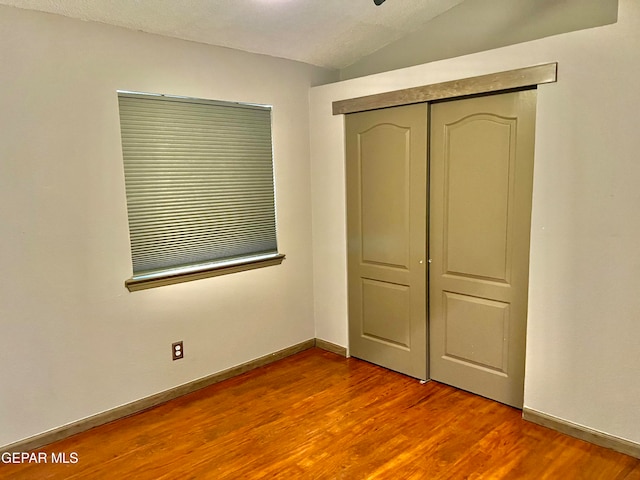 unfurnished bedroom featuring hardwood / wood-style flooring and a closet