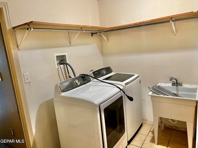 laundry room with light tile patterned flooring and washing machine and dryer