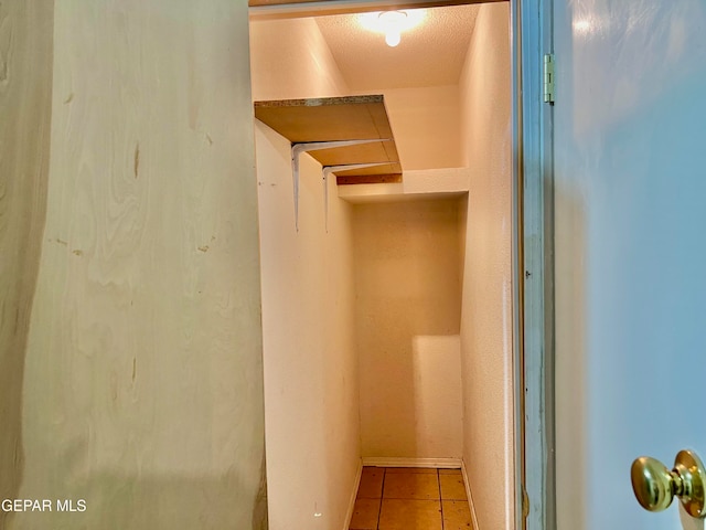 walk in closet featuring light tile patterned floors