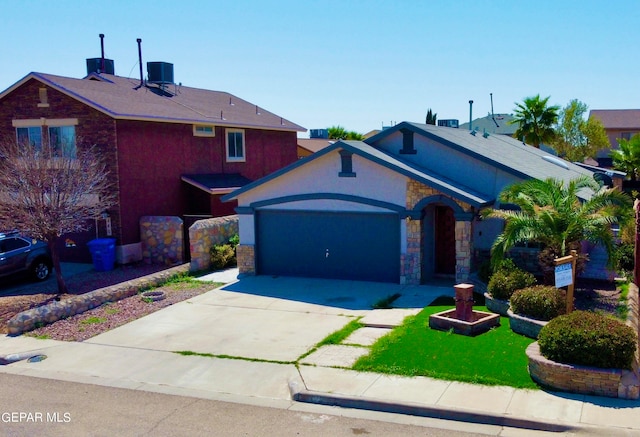 view of front of property featuring cooling unit and a garage