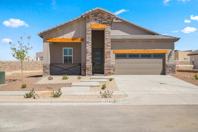 12741 Eltham Dr, Horizon City, TX 79928 - view of front facade featuring board and batten siding, concrete driveway, stone siding, and a garage