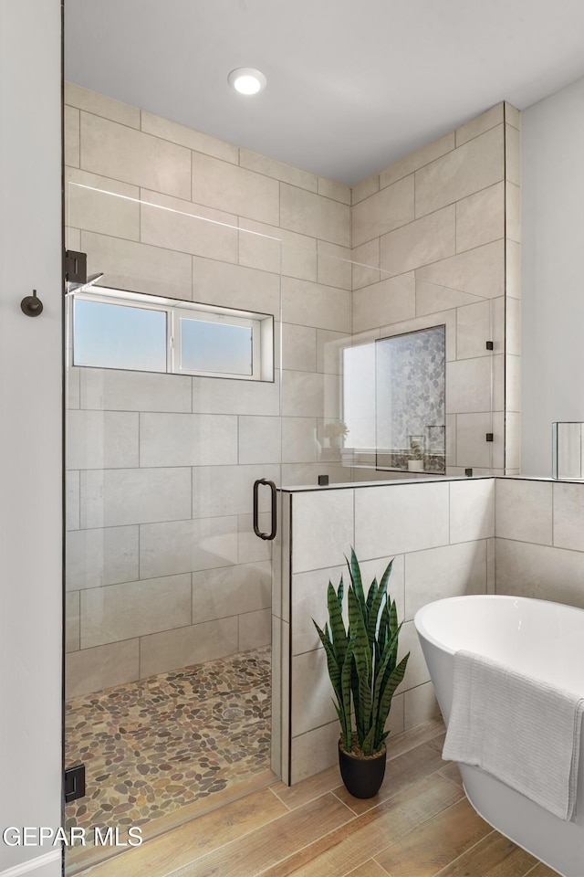 12741 Eltham Dr, Horizon City, TX 79928 - full bath with a freestanding bath, a shower stall, recessed lighting, and wood finished floors