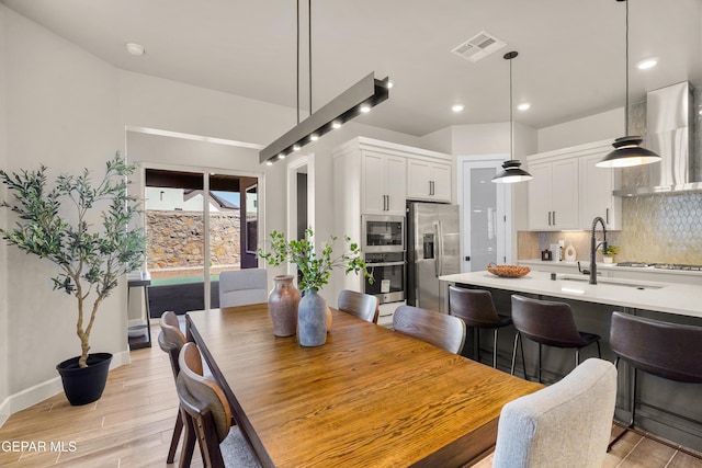 12741 Eltham Dr, Horizon City, TX 79928 - dining space with light wood-style floors, baseboards, recessed lighting, and visible vents