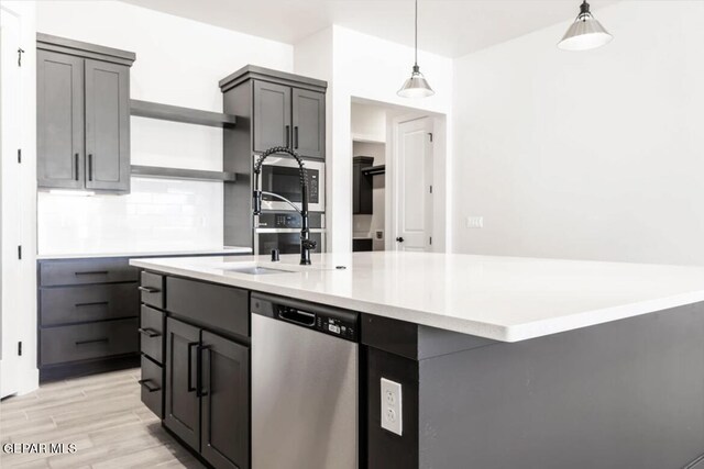 kitchen with decorative backsplash, pendant lighting, dishwasher, light hardwood / wood-style floors, and gray cabinetry