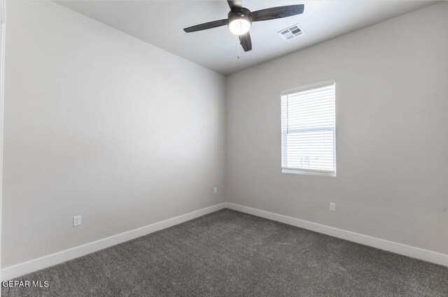 spare room featuring carpet and ceiling fan