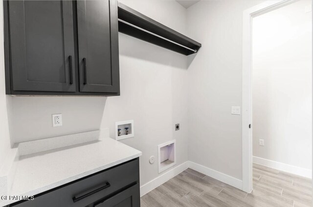 clothes washing area with light hardwood / wood-style flooring, cabinets, hookup for an electric dryer, gas dryer hookup, and washer hookup