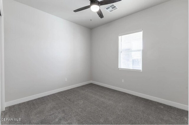 empty room featuring carpet floors and ceiling fan