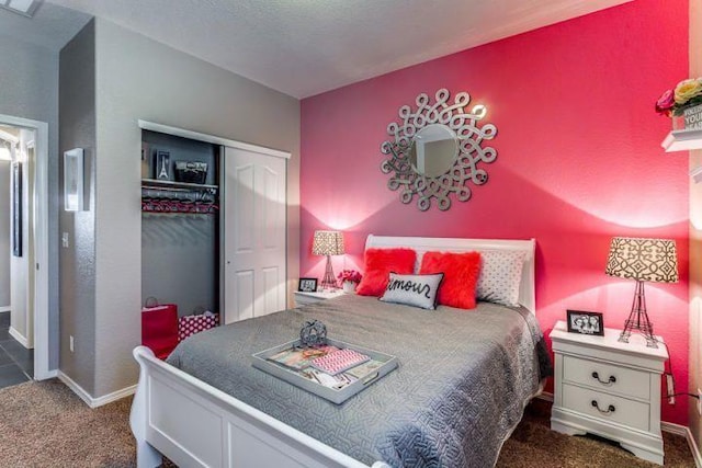 bedroom featuring a closet and dark colored carpet