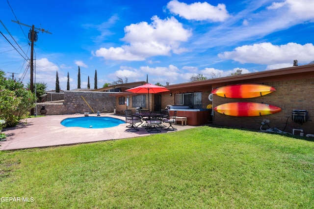 view of pool featuring a patio area, a hot tub, and a lawn