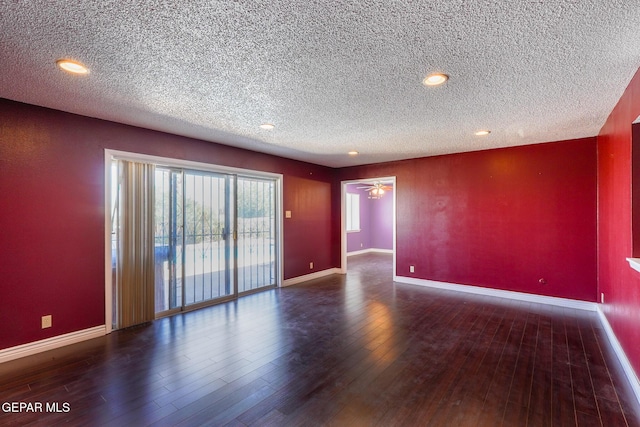 spare room with ceiling fan, a textured ceiling, and dark hardwood / wood-style flooring