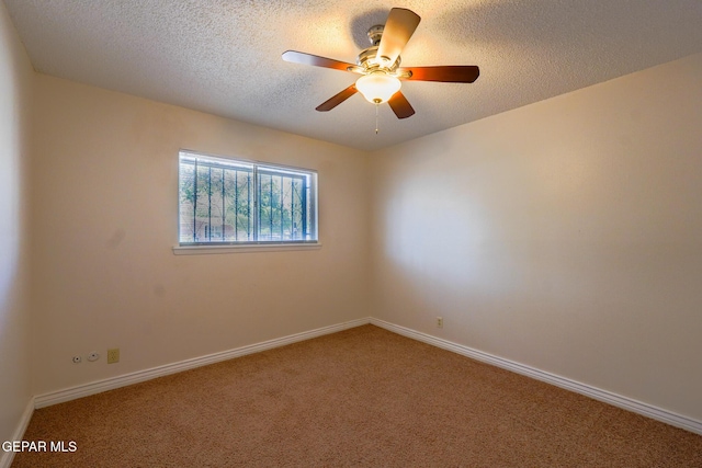 carpeted empty room featuring ceiling fan and a textured ceiling