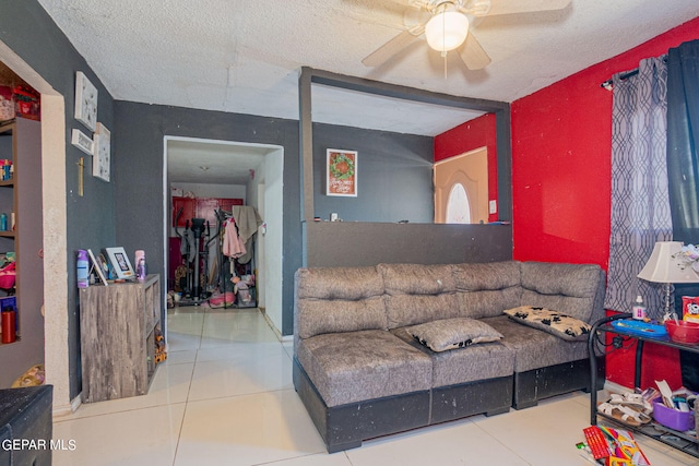 tiled living room featuring ceiling fan and a textured ceiling