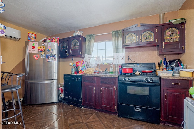 kitchen featuring black appliances, dark brown cabinets, a wall mounted air conditioner, and light countertops