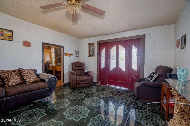 entrance foyer featuring a textured ceiling and ceiling fan