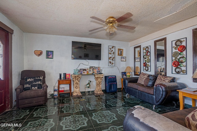 living area with ceiling fan and a textured ceiling