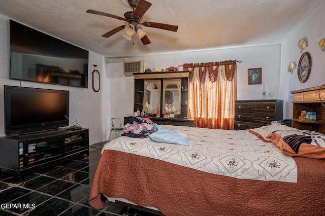 bedroom featuring ceiling fan and a textured ceiling