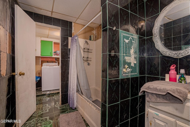 full bath featuring washer / dryer, shower / tub combo with curtain, vanity, a paneled ceiling, and tile walls