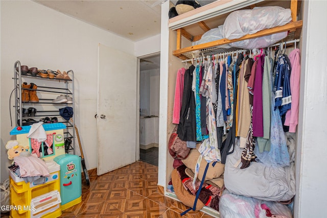 walk in closet featuring dark floors