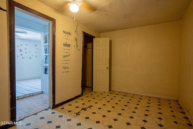 empty room featuring light floors, ceiling fan, and baseboards