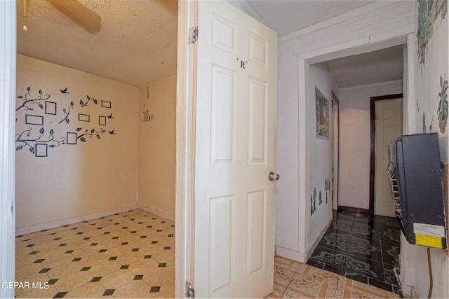 hall featuring baseboards and light floors