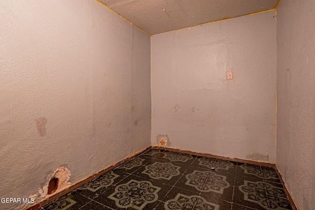 spare room featuring lofted ceiling