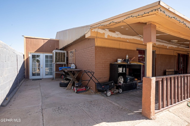 view of side of home featuring a patio, french doors, central AC unit, and fence