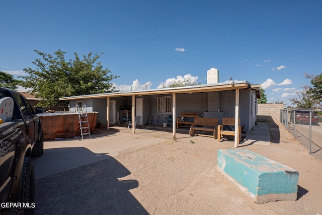 rear view of property featuring an exterior structure, an outdoor structure, and a chimney