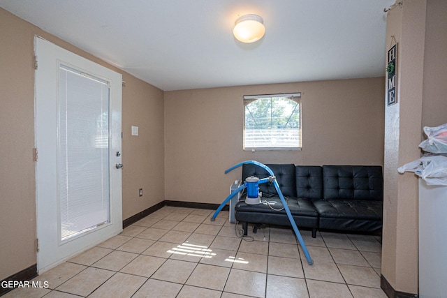 game room featuring light tile patterned flooring and baseboards