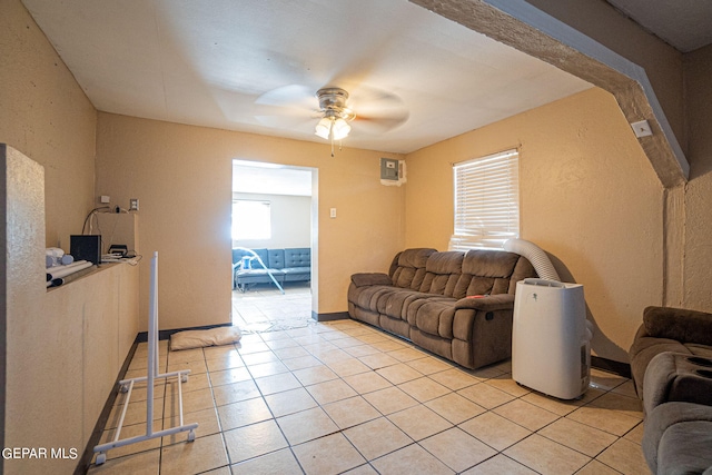 living room featuring baseboards, a ceiling fan, and light tile patterned flooring