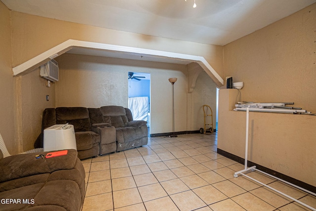 bonus room featuring light tile patterned floors, a ceiling fan, and a wall mounted AC