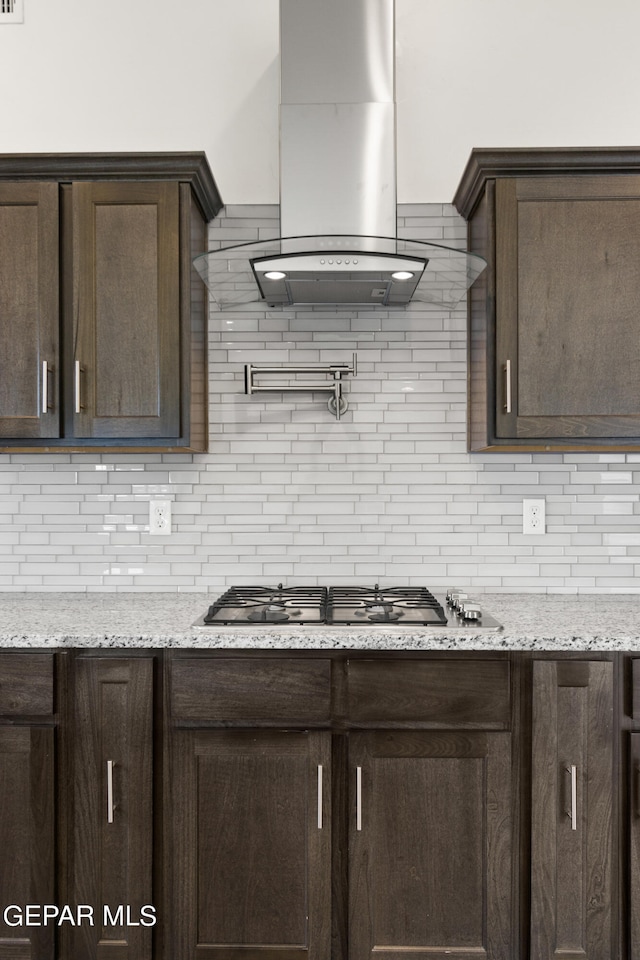 kitchen with tasteful backsplash and dark brown cabinetry