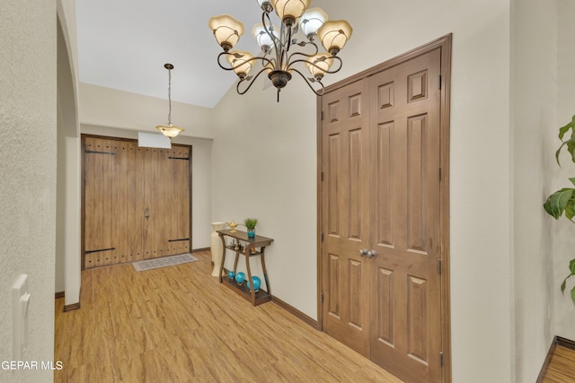 interior space with light hardwood / wood-style flooring and an inviting chandelier