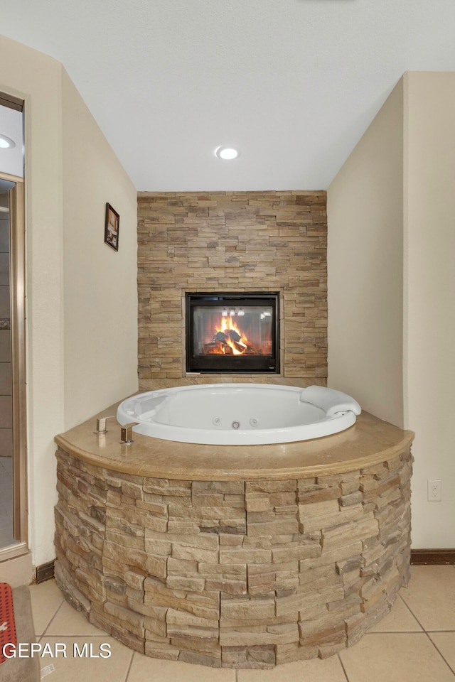 bathroom featuring tiled tub and tile patterned floors