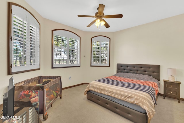 bedroom with light carpet and ceiling fan