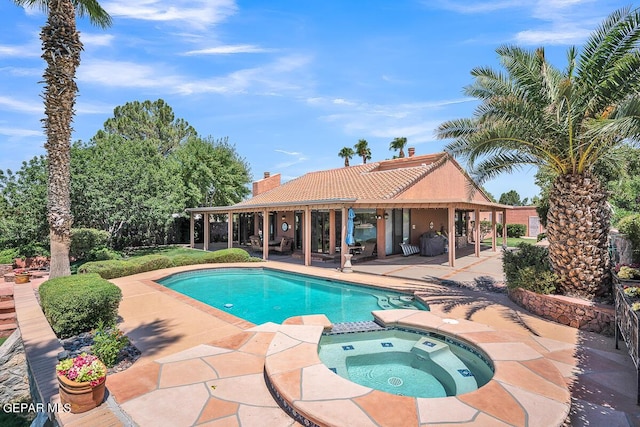 view of swimming pool with an in ground hot tub and a patio