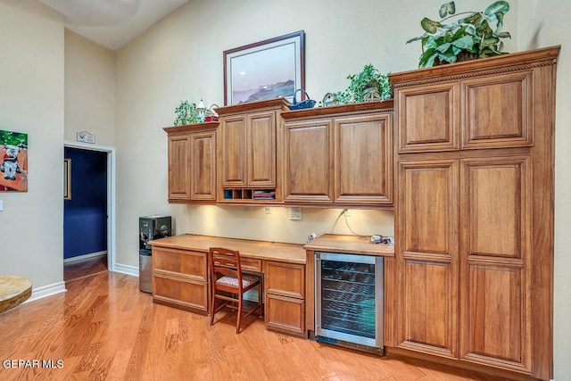 office area featuring wine cooler and light wood-type flooring