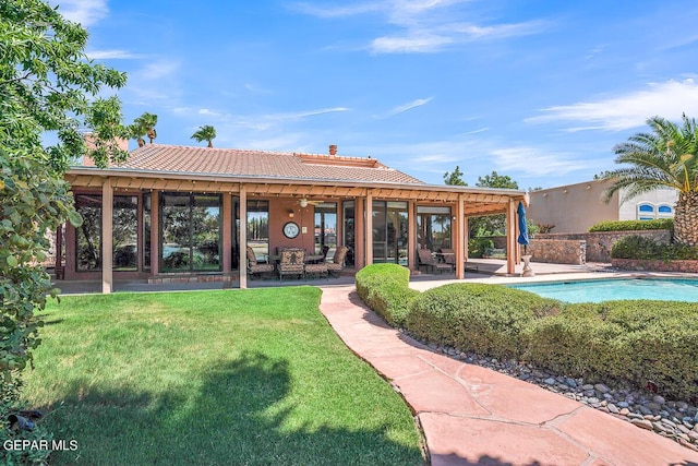 back of house with a yard and a patio area