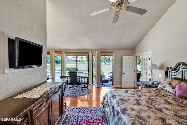 bedroom featuring lofted ceiling, light hardwood / wood-style flooring, ceiling fan, a textured ceiling, and access to outside