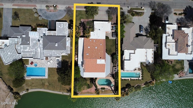 birds eye view of property with a water view