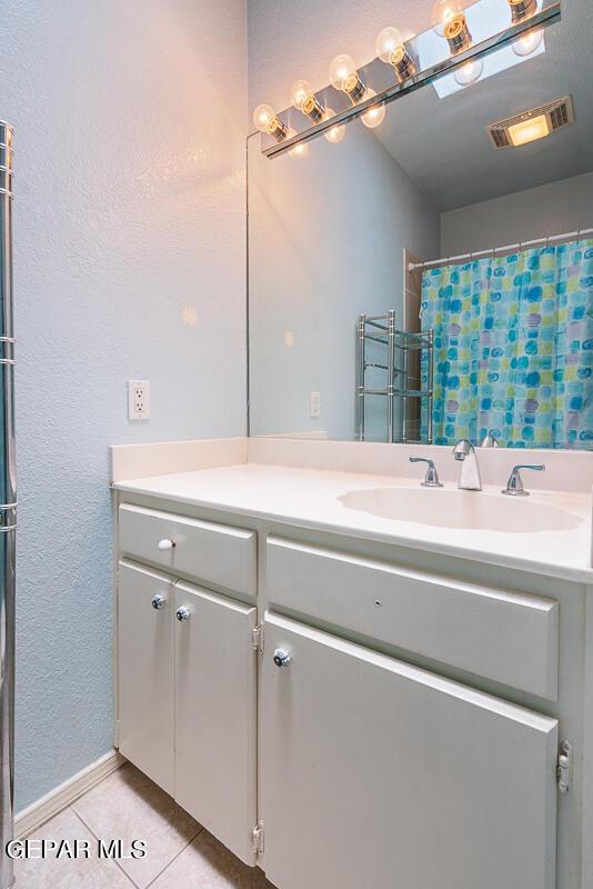 bathroom with vanity, tile patterned floors, and a shower with shower curtain