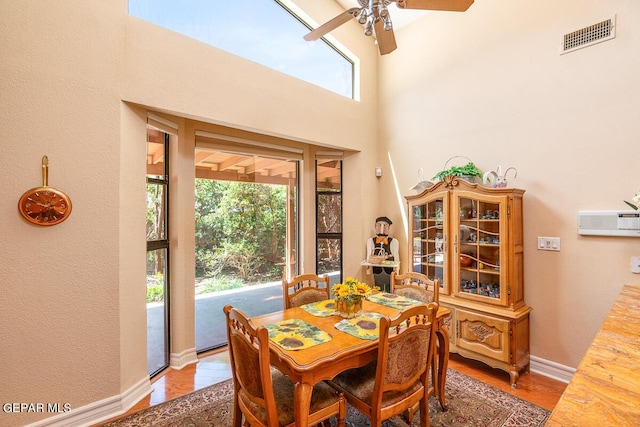 dining room with hardwood / wood-style floors and ceiling fan