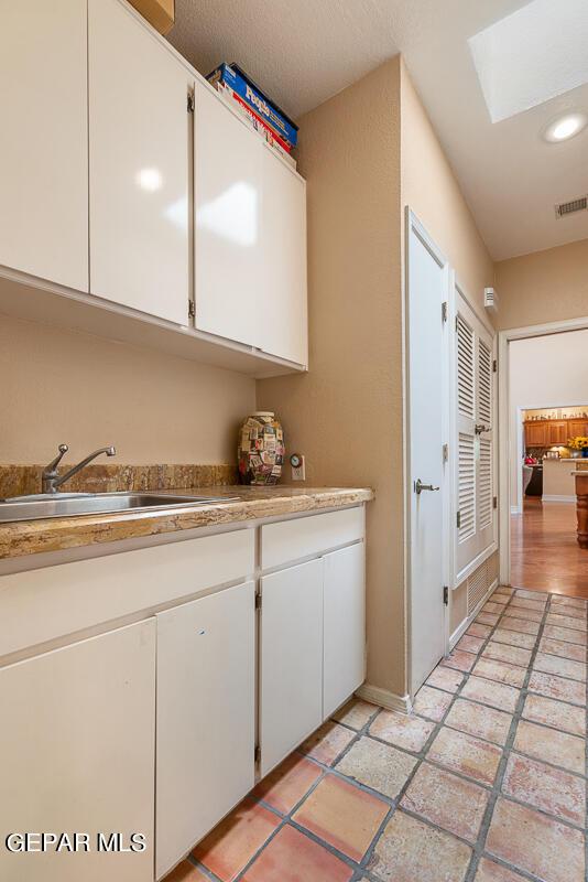 laundry area with sink and a skylight