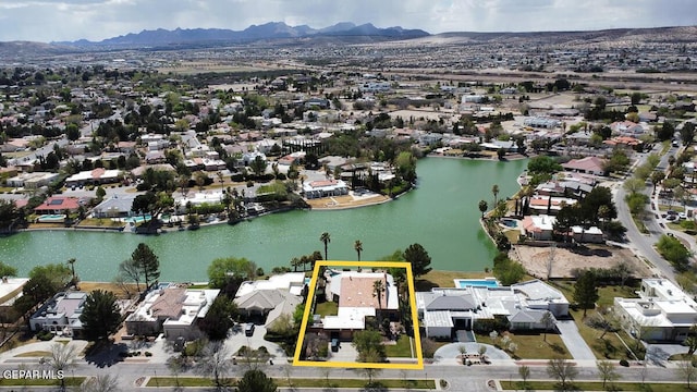 drone / aerial view with a water and mountain view