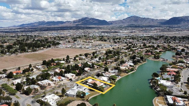 birds eye view of property featuring a water and mountain view