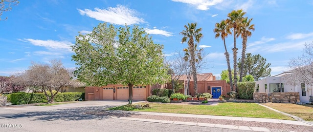 view of front of home featuring a garage and a front lawn