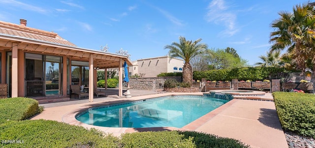 view of pool featuring a patio and an in ground hot tub